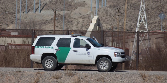 FILE PHOTO: Border Patrol agents detain migrants after crossing the Rio Grande natural border between El Paso, state of Texas, US, and Ciudad Juarez, Chihuahua state, Mexico.