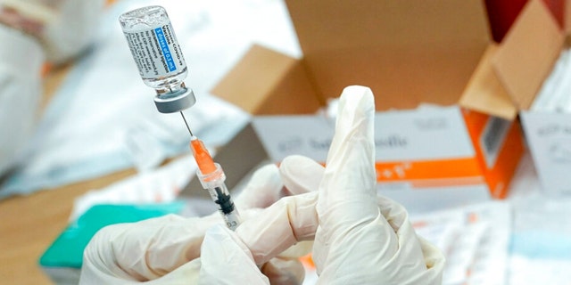 A nurse fills a syringe with the Johnson & Johnson COVID-19 vaccine.