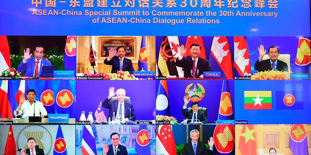 This image provided by Malaysia Prime Minister Office shows ASEAN leaders and Chinese President Xi Jinping, top, second from right, on screen during an online meeting of the ASEAN-China special summit in Kuala Lumpur, Malaysia, Monday, Nov. 22, 2021.