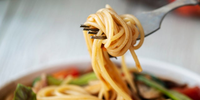 Spaghetti is swirled onto a fork. Try whole-grain pasta choices as part of a heathy diet.