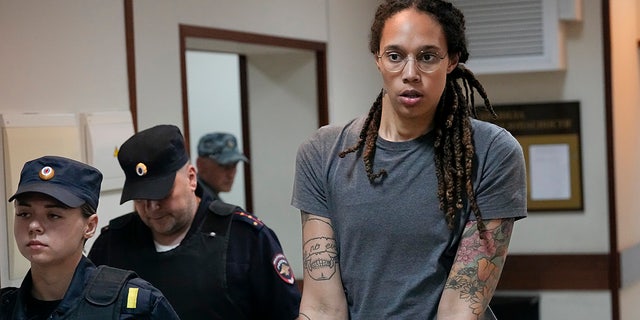 WNBA star and two-time Olympic gold medalist Brittney Griner is escorted from a courtroom after a hearing in Khimki just outside Moscow, Russia, Aug. 4, 2022.