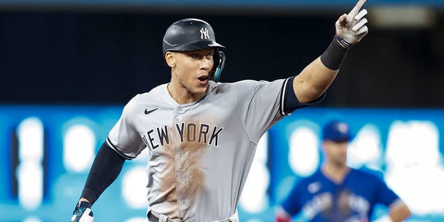 Aaron Judge, #99 of the New York Yankees, runs the bases as he hits his 61st home run of the season in the seventh inning against the Toronto Blue Jays at Rogers Centre on Sept. 28, 2022 in Toronto. Judge has now tied Roger Maris for the American League record.