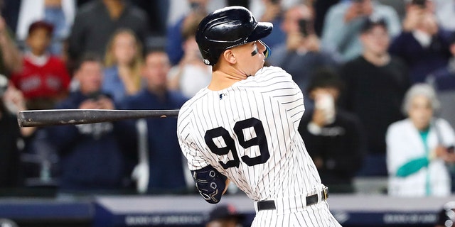 New York Yankees designated hitter Aaron Judge follows through on a double against Boston Red Sox starting pitcher Brayan Bello during the first inning of a baseball game Sunday, Sept. 25, 2022, in New York.