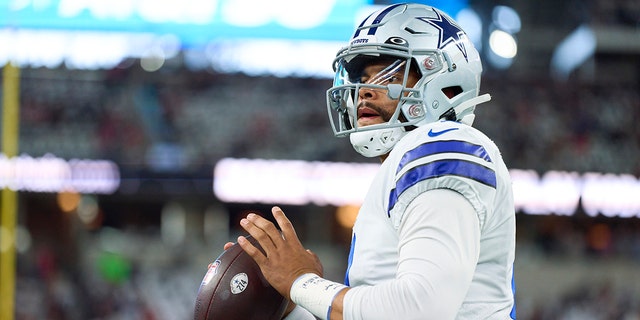 Dak Prescott #4 of the Dallas Cowboys warms up before kickoff against the Tampa Bay Buccaneers at AT&T Stadium on September 11, 2022 in Arlington, TX.