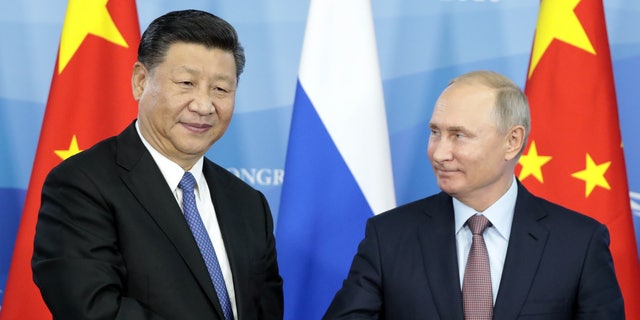 Russia's President Vladimir Putin, right, shakes hands with his China President Xi Jinping during a signing ceremony following the Russian-Chinese talks on the sidelines of the Eastern Economic Forum in Vladivostok Sept. 11, 2018.