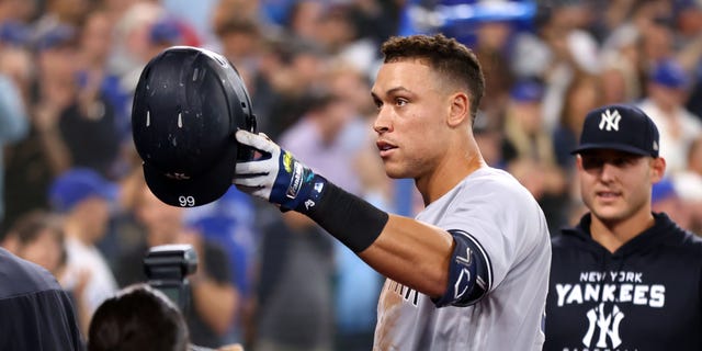 Aaron Judge, #99 of the New York Yankees, tips his hat towards his mother after hitting his 61st home run of the season in the seventh inning against the Toronto Blue Jays at Rogers Centre on Sept. 28, 2022 in Toronto. Judge has now tied Roger Maris for the American League record.