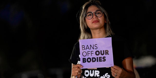 Celina Washburn protests outside the Arizona Capitol to voice her dissent with an abortion ruling, Friday, Sept. 23, 2022, in Phoenix.