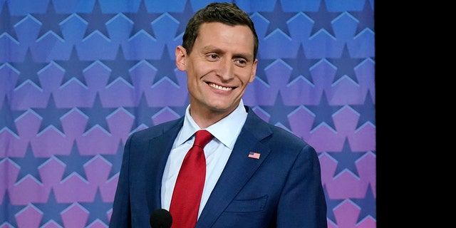 Republican Senate challenger Blake Masters smiles on stage prior to a televised debate with Arizona Democratic Sen. Mark Kelly and Libertarian candidate Marc Victor in Phoenix, Thursday, Oct. 6, 2022.