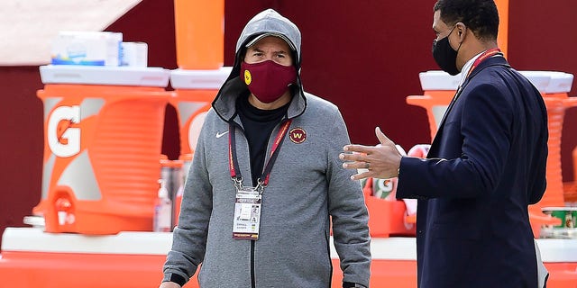 Daniel Snyder, left, talks with team president Jason Wright on the sidelines before the Cincinnati Bengals game at FedExField on Nov. 22, 2020, in Landover, Maryland.