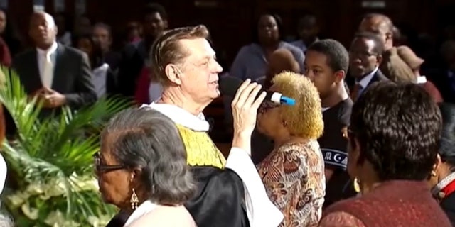 File photo of Father Michael Pfleger performing a sermon.