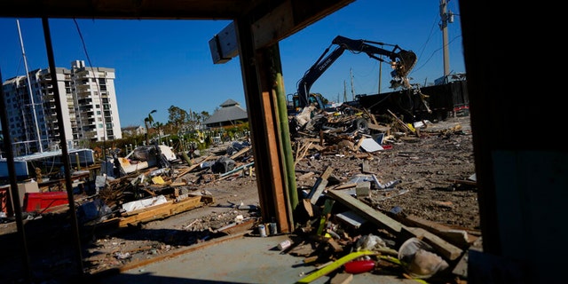 A decorative item recovered from the wreckage of Getaway Marina sits on a table to be saved, as owner Robert Leisure begins the long process of rebuilding his business after the passage of Hurricane Ian, on San Carlos Boulevard in Fort Myers Beach, Fla., Sunday, Oct. 2, 2022.