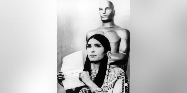 Sacheen Littlefeather holds a written statement from actor Marlon Brando refusing his Best Actor Oscar on stage at the Academy Awards, Los Angeles, California.