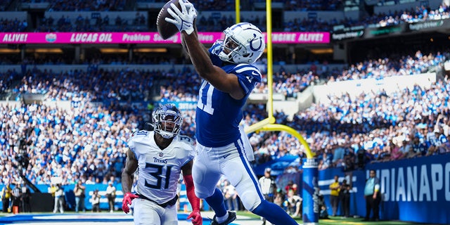 Indianapolis Colts wide receiver Michael Pittman Jr. attempts a catch in front of Tennessee Titans safety Kevin Byard in the first half of an NFL football game in Indianapolis, Fla., Sunday, Oct. 2, 2022. The pass was ruled incomplete.
