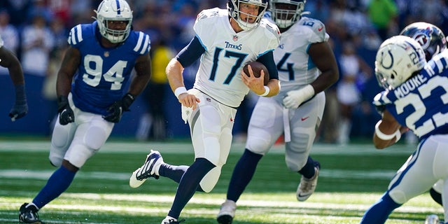 Tennessee Titans quarterback Ryan Tannehill scramble away from Indianapolis Colts defensive end Tyquan Lewis in the first half of an NFL football game in Indianapolis, Fla., Sunday, Oct. 2, 2022.