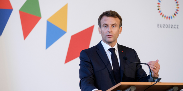 French President Emmanuel Macron talks to media at the end of an informal EU leaders summit on Oct. 7, 2022 in Prague, Czech Republic.