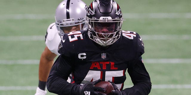 Deion Jones #45 of the Atlanta Falcons runs after intercepting a pass by Derek Carr #4 of the Las Vegas Raiders for a during their NFL game at Mercedes-Benz Stadium on November 29, 2020 in Atlanta, Georgia.